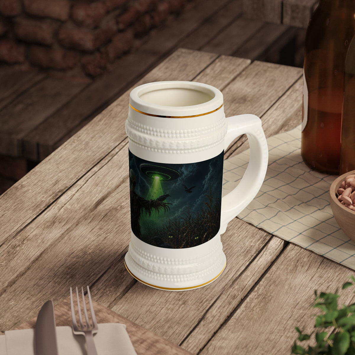 Alien scarecrow beer stein with gold trim on a wooden table, showing a green UFO beam above a moonlit field